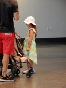 Little Girl Next to a Stroller