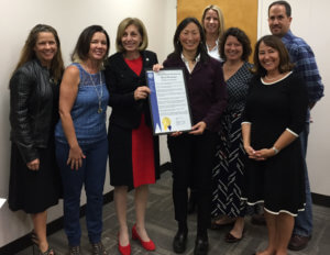 Council President Bry presents Workplace Gender Equity Day proclamation to Hei-ock Kim, along with members of the Councilmember's Workplace Equity Initiative